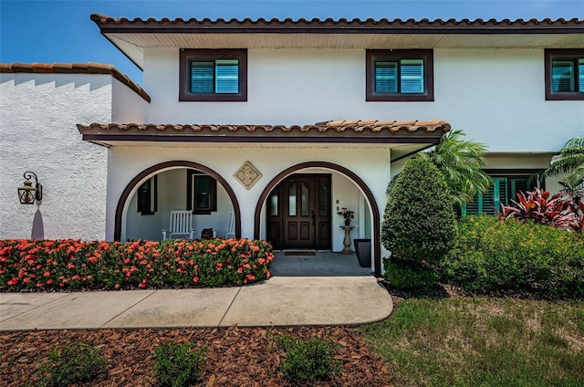 10866 Harborside Dr, Largo, FL 33773 - mediterranean / spanish-style house with covered porch and stucco siding