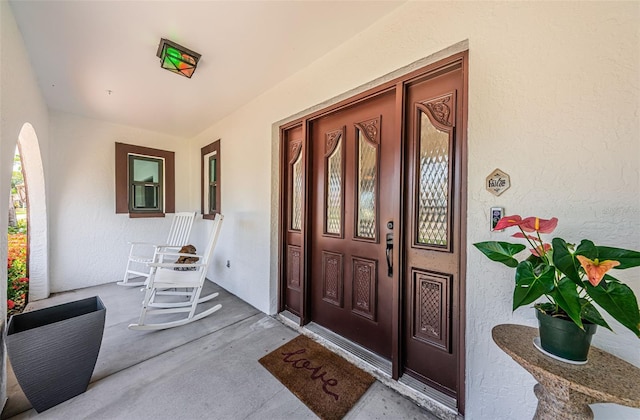 10866 Harborside Dr, Largo, FL 33773 - view of exterior entry featuring stucco siding and covered porch