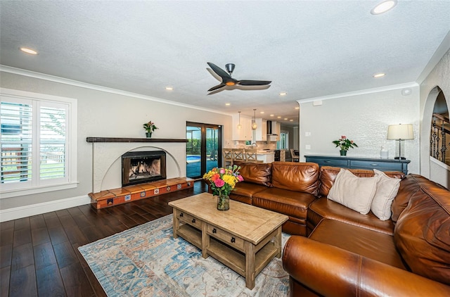 10866 Harborside Dr, Largo, FL 33773 - living area with ornamental molding, a ceiling fan, wood finished floors, a textured ceiling, and a fireplace