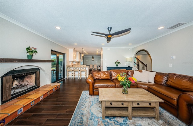 10866 Harborside Dr, Largo, FL 33773 - living area featuring a ceiling fan, wood finished floors, a fireplace with raised hearth, ornamental molding, and recessed lighting