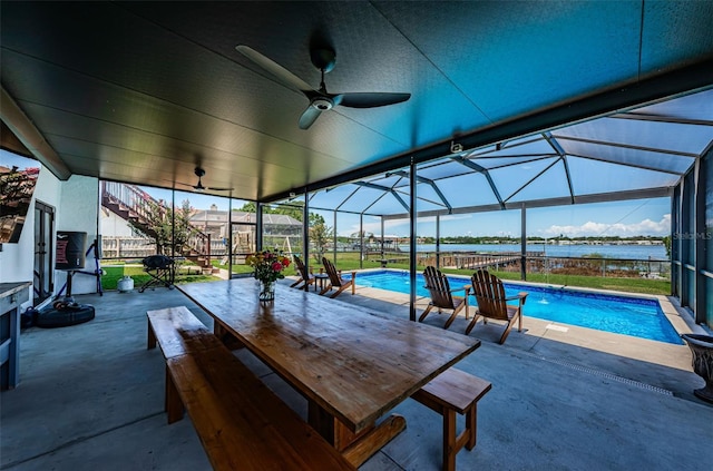 10866 Harborside Dr, Largo, FL 33773 - outdoor pool featuring a patio, ceiling fan, a water view, glass enclosure, and outdoor dining space