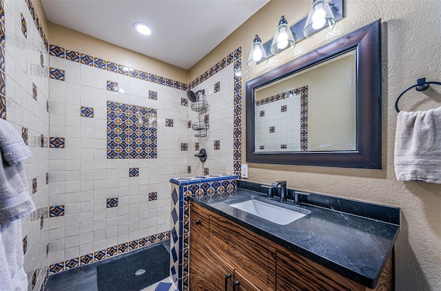 10866 Harborside Dr, Largo, FL 33773 - bathroom featuring vanity, a tile shower, and a textured wall
