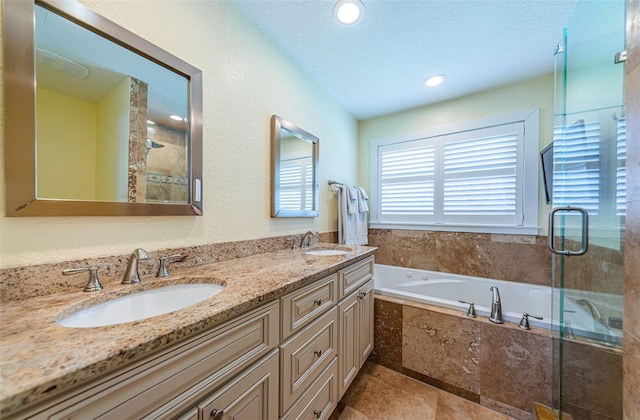 10866 Harborside Dr, Largo, FL 33773 - bathroom featuring a garden tub, a stall shower, double vanity, recessed lighting, and a textured ceiling
