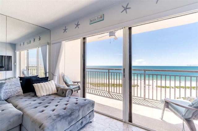 1270 Gulf Blvd Unit 1605, Clearwater Beach, FL 33767 - sunroom featuring marble look tiles and view of water and beach