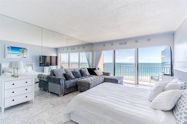 1270 Gulf Blvd Unit 1605, Clearwater Beach, FL 33767 - bedroom featuring access to outside, light marble finish floors, and a textured ceiling