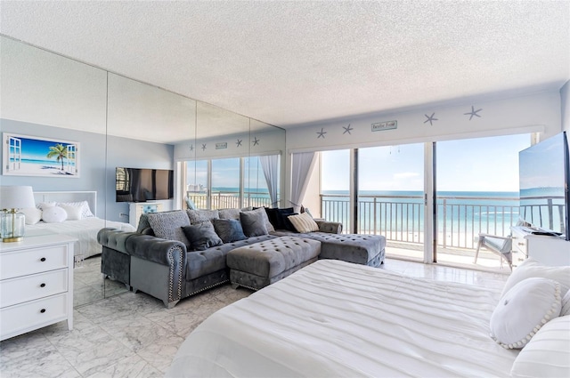 1270 Gulf Blvd Unit 1605, Clearwater Beach, FL 33767 - bedroom with light marble finish floors, access to outside, and a textured ceiling