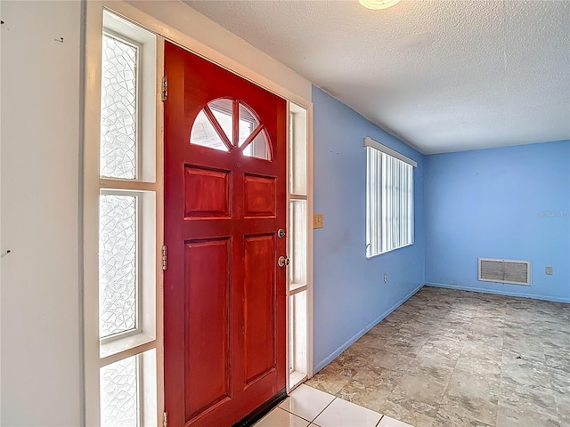 6250 7th Ave, New Port Richey, FL 34653 - foyer with a textured ceiling and baseboards