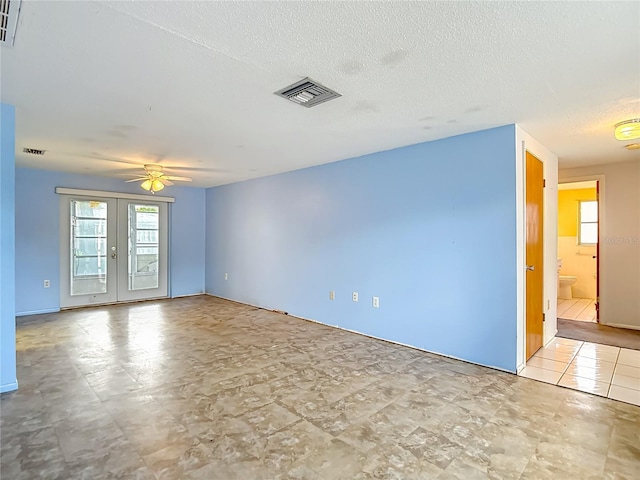 6250 7th Ave, New Port Richey, FL 34653 - unfurnished room with french doors, a ceiling fan, and a textured ceiling