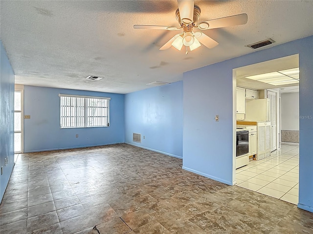6250 7th Ave, New Port Richey, FL 34653 - empty room with a textured ceiling and ceiling fan