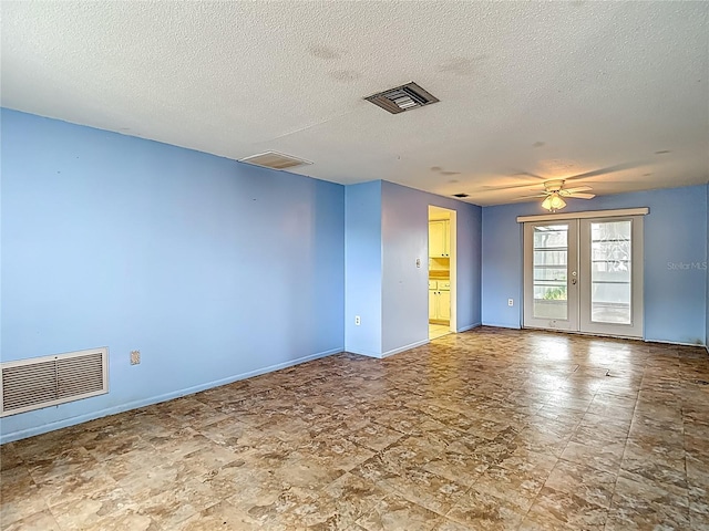 6250 7th Ave, New Port Richey, FL 34653 - unfurnished room featuring a textured ceiling, ceiling fan, and french doors
