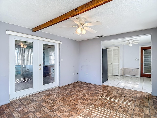 6250 7th Ave, New Port Richey, FL 34653 - spare room featuring ceiling fan, french doors, brick patterned floors, a textured ceiling, and beam ceiling