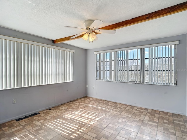 6250 7th Ave, New Port Richey, FL 34653 - empty room featuring ceiling fan, plenty of natural light, brick patterned flooring, a textured ceiling, and beamed ceiling