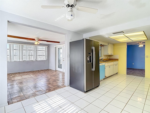 6250 7th Ave, New Port Richey, FL 34653 - kitchen featuring stainless steel refrigerator with ice dispenser, ceiling fan, open floor plan, light countertops, and a textured ceiling