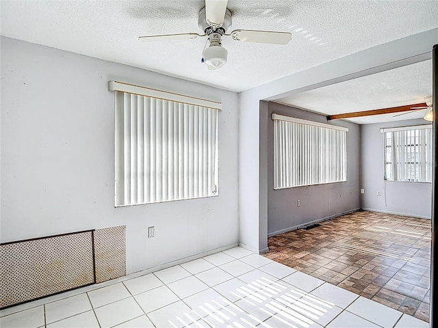 6250 7th Ave, New Port Richey, FL 34653 - spare room with ceiling fan, a textured ceiling, and brick patterned floors