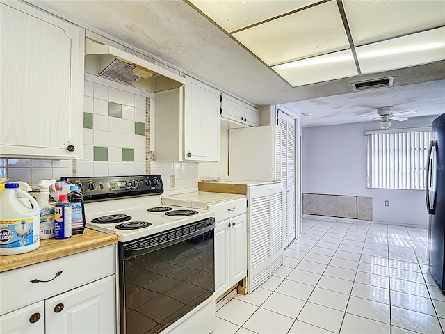 6250 7th Ave, New Port Richey, FL 34653 - kitchen with white electric range, under cabinet range hood, light countertops, and white cabinetry