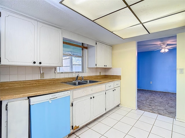 6250 7th Ave, New Port Richey, FL 34653 - kitchen with dishwasher, backsplash, ceiling fan, white cabinets, and light tile patterned floors