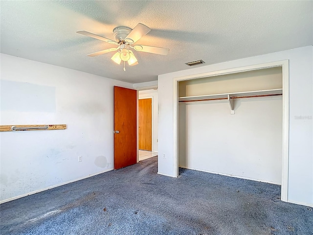 6250 7th Ave, New Port Richey, FL 34653 - unfurnished bedroom featuring carpet, a closet, a ceiling fan, and a textured ceiling