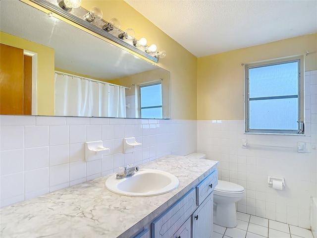 6250 7th Ave, New Port Richey, FL 34653 - full bath with tile patterned floors, vanity, tile walls, a textured ceiling, and a wainscoted wall