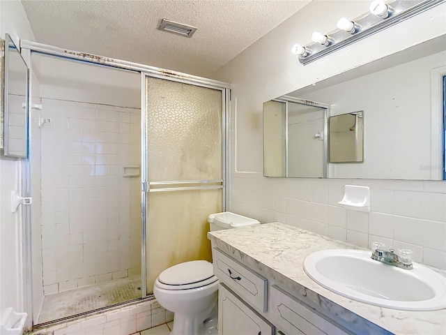 6250 7th Ave, New Port Richey, FL 34653 - full bathroom with a stall shower, a textured ceiling, vanity, decorative backsplash, and tile walls