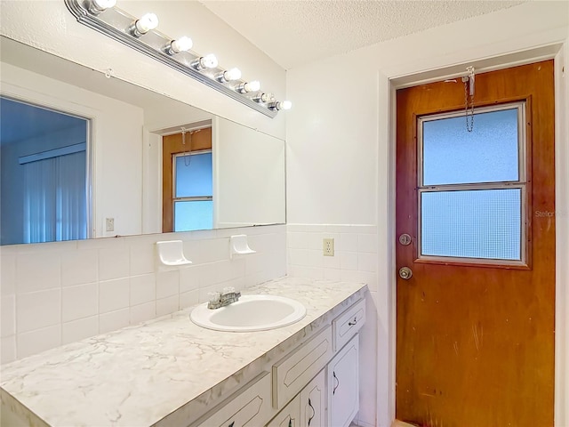 6250 7th Ave, New Port Richey, FL 34653 - bathroom featuring vanity, tasteful backsplash, healthy amount of natural light, and a textured ceiling