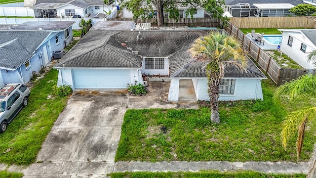6250 7th Ave, New Port Richey, FL 34653 - view of front of home with a residential view, concrete driveway, and a garage