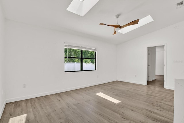 10319 Alberta Ct, New Port Richey, FL 34654 - unfurnished room featuring a skylight, vaulted ceiling, and wood finished floors