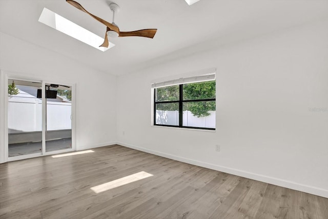 10319 Alberta Ct, New Port Richey, FL 34654 - unfurnished room with plenty of natural light, wood finished floors, a skylight, and a ceiling fan