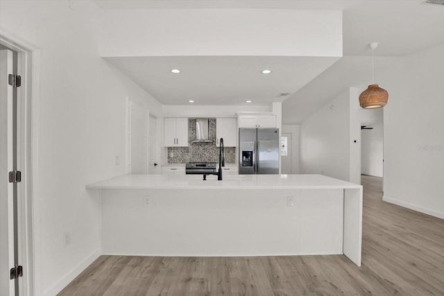 10319 Alberta Ct, New Port Richey, FL 34654 - kitchen with appliances with stainless steel finishes, wall chimney range hood, white cabinets, light countertops, and recessed lighting