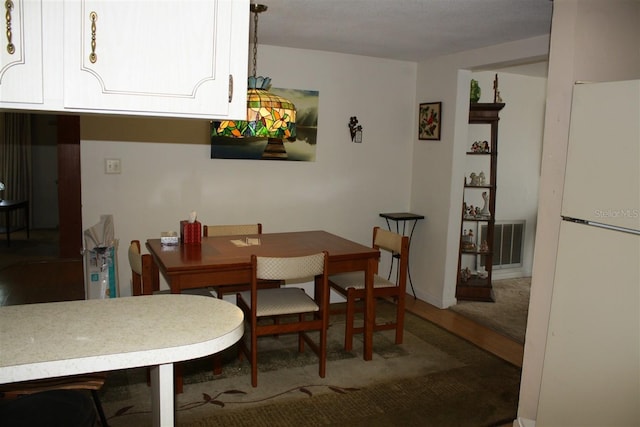 7534 Betula Dr, New Port Richey, FL 34653 - dining area with wood finished floors