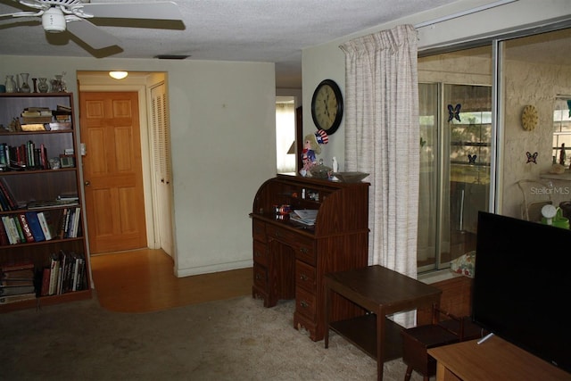 7534 Betula Dr, New Port Richey, FL 34653 - carpeted home office featuring a ceiling fan, plenty of natural light, and a textured ceiling