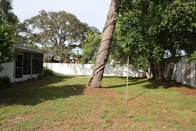 7534 Betula Dr, New Port Richey, FL 34653 - fenced backyard featuring a sunroom