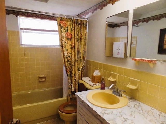 7534 Betula Dr, New Port Richey, FL 34653 - full bathroom with shower / tub combo with curtain, vanity, tile walls, and wainscoting