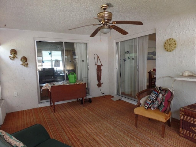 7534 Betula Dr, New Port Richey, FL 34653 - living room with a textured ceiling, ceiling fan, and a textured wall