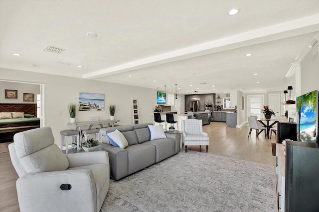 11890 Walker Ave, Seminole, FL 33772 - living room featuring light wood finished floors, recessed lighting, and beam ceiling