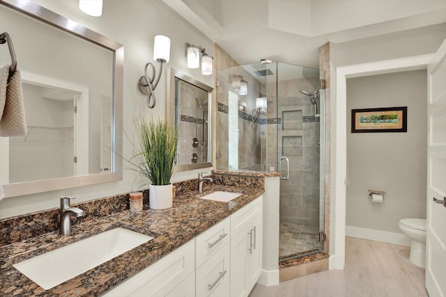 11890 Walker Ave, Seminole, FL 33772 - full bathroom featuring double vanity, a shower stall, and a walk in closet