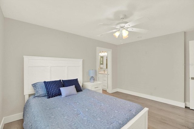 11890 Walker Ave, Seminole, FL 33772 - bedroom with light wood-style floors, a ceiling fan, and connected bathroom