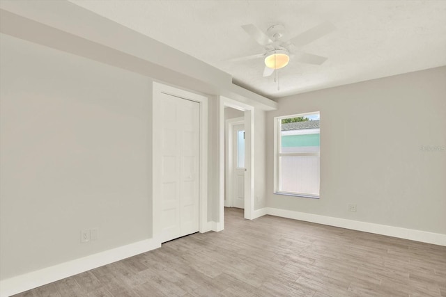 11890 Walker Ave, Seminole, FL 33772 - unfurnished bedroom featuring wood finished floors, a ceiling fan, and a closet