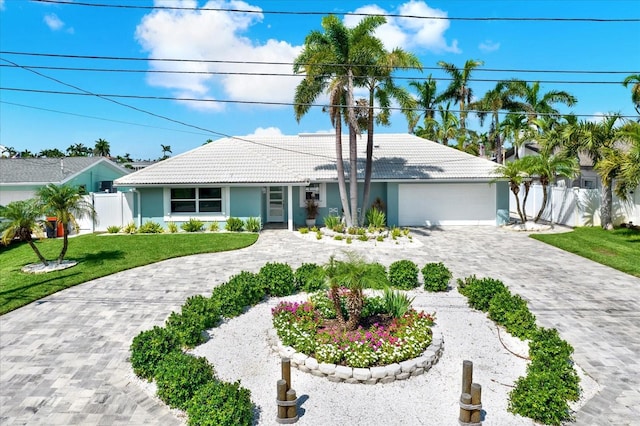 11890 Walker Ave, Seminole, FL 33772 - ranch-style house with a tile roof, decorative driveway, a garage, and stucco siding