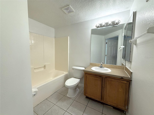 6448 Cypressdale Dr Unit 101, Riverview, FL 33578 - full bathroom with vanity, tile patterned floors, a textured ceiling, a textured wall, and washtub / shower combination