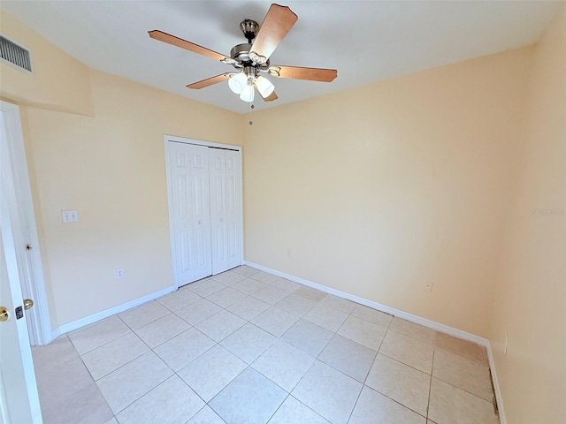 6448 Cypressdale Dr Unit 101, Riverview, FL 33578 - unfurnished bedroom featuring light tile patterned flooring, a closet, and a ceiling fan