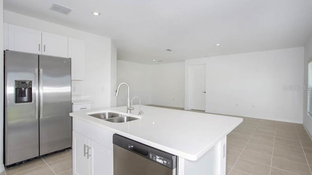 2091 Babbling Brook Blvd, Auburndale, FL 33823 - kitchen with appliances with stainless steel finishes, light tile patterned floors, white cabinetry, light countertops, and an island with sink