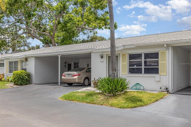 6015 Arlene Way, Bradenton, FL 34207 - ranch-style home featuring an attached carport, a shingled roof, driveway, and concrete block siding