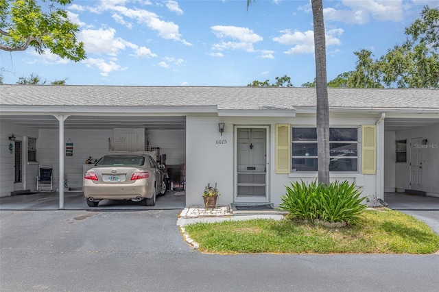 6015 Arlene Way, Bradenton, FL 34207 - ranch-style house with a carport, a shingled roof, and driveway