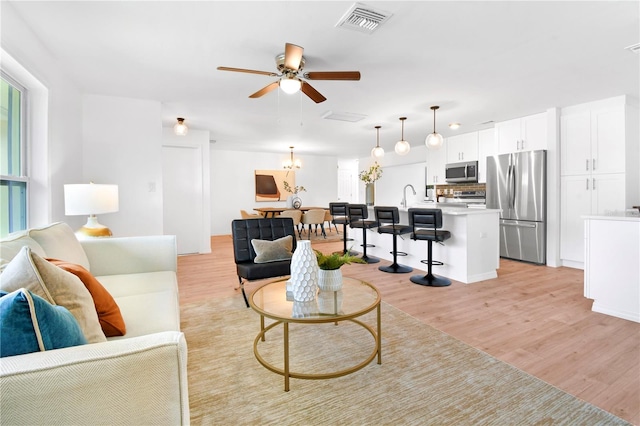13344 Sorrento Dr, Largo, FL 33774 - living area featuring ceiling fan and light wood-type flooring