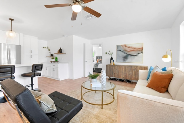 13344 Sorrento Dr, Largo, FL 33774 - living area featuring a ceiling fan and light wood-type flooring