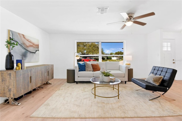 13344 Sorrento Dr, Largo, FL 33774 - living area with wood finished floors, healthy amount of natural light, and a ceiling fan