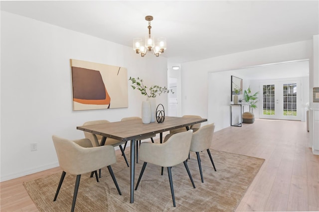 13344 Sorrento Dr, Largo, FL 33774 - dining area featuring a chandelier and light wood-type flooring