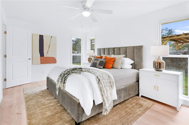 13344 Sorrento Dr, Largo, FL 33774 - bedroom featuring light wood-style floors, multiple windows, and a ceiling fan