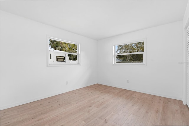 13344 Sorrento Dr, Largo, FL 33774 - unfurnished room featuring healthy amount of natural light and light wood-type flooring