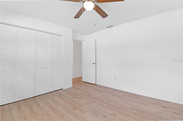 13344 Sorrento Dr, Largo, FL 33774 - unfurnished bedroom with light wood-style flooring, a closet, and ceiling fan